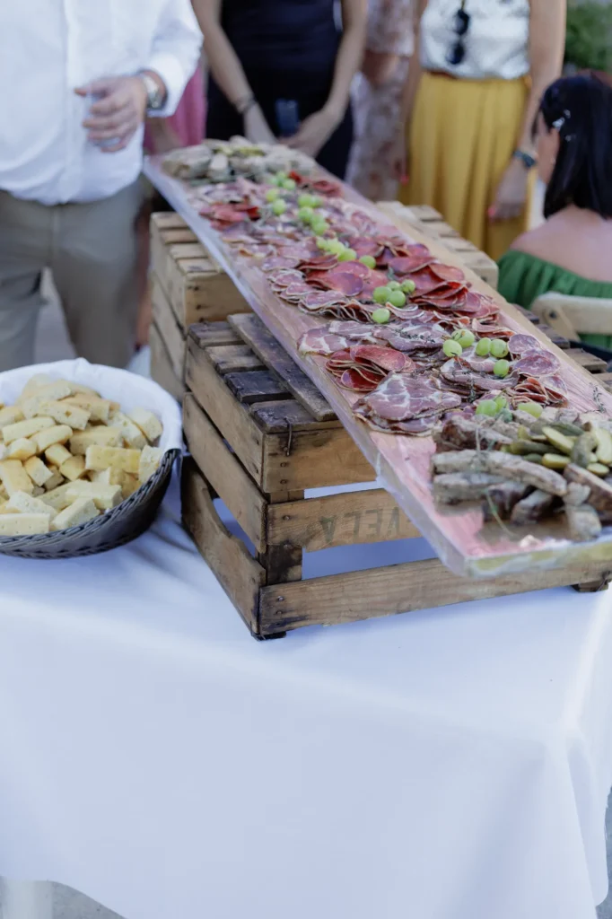 Buffet de bouchées présenté sur une table en bois pendant le cocktail de mariage
