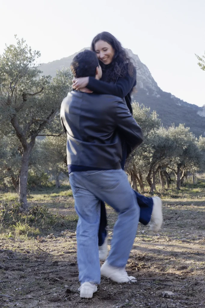Couple riant dans une oliveraie pendant une séance photo en Provence